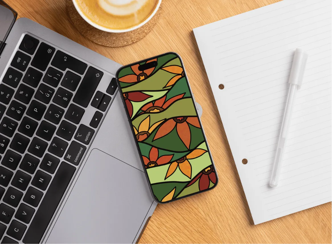 Portátil y teléfono mostrando ilustraciones de Flowaura sobre un escritorio